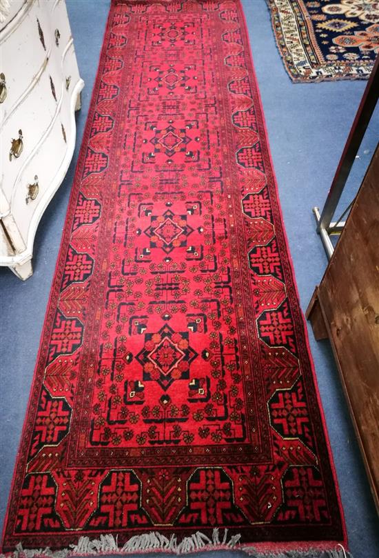 A Belouch red ground runner 290 x 81cm